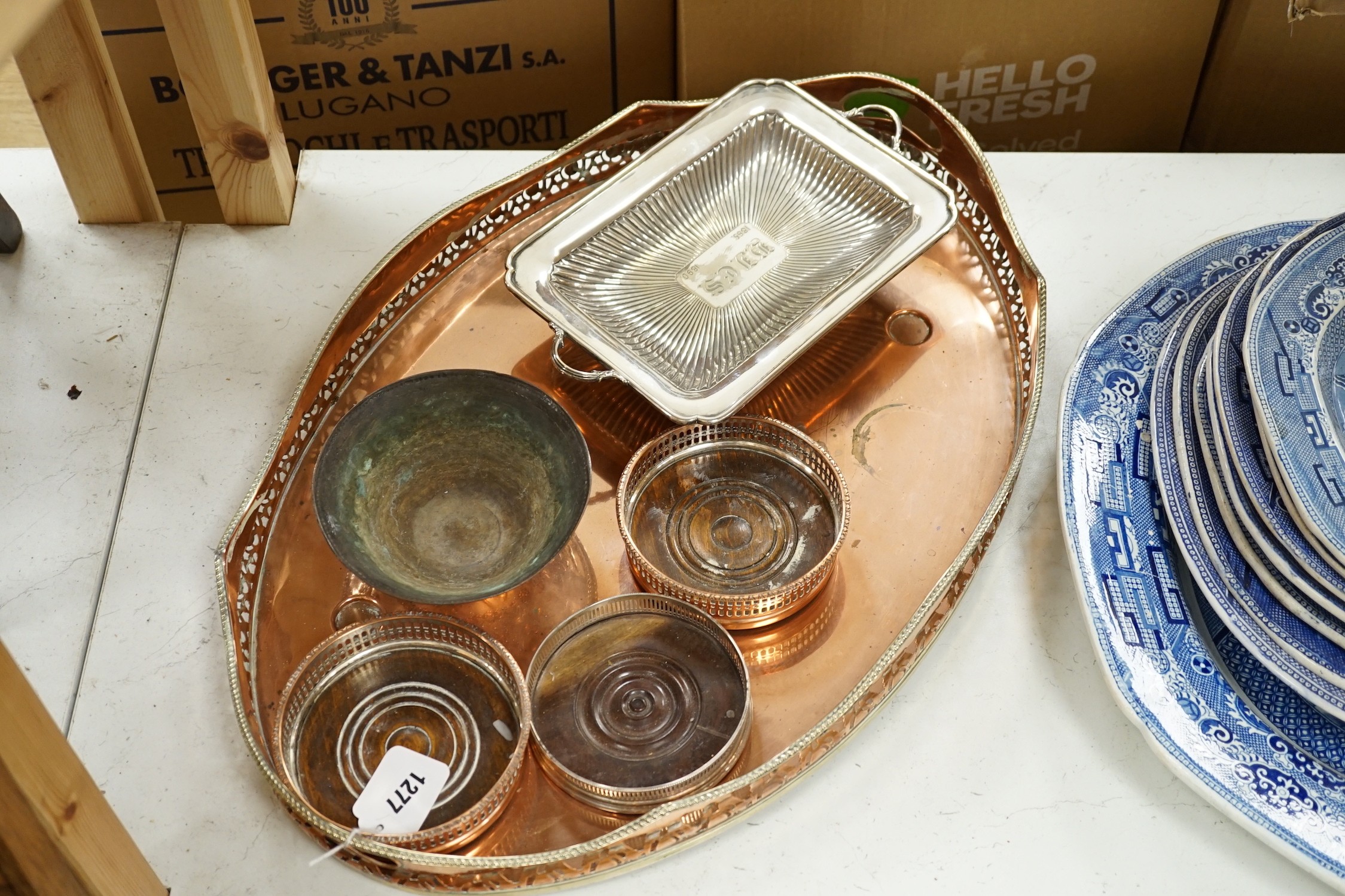 Three copper coasters, an oval tray plated bowl and entree dish